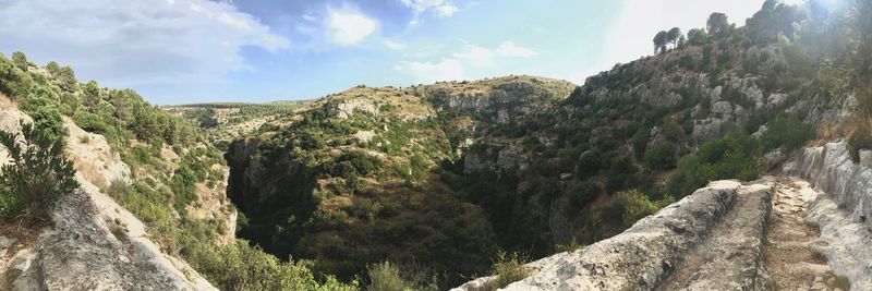 Panoramic view of rocky mountains against sky