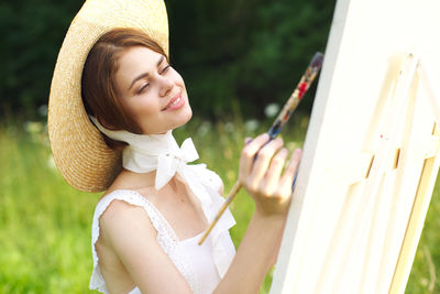 Portrait of young woman wearing hat