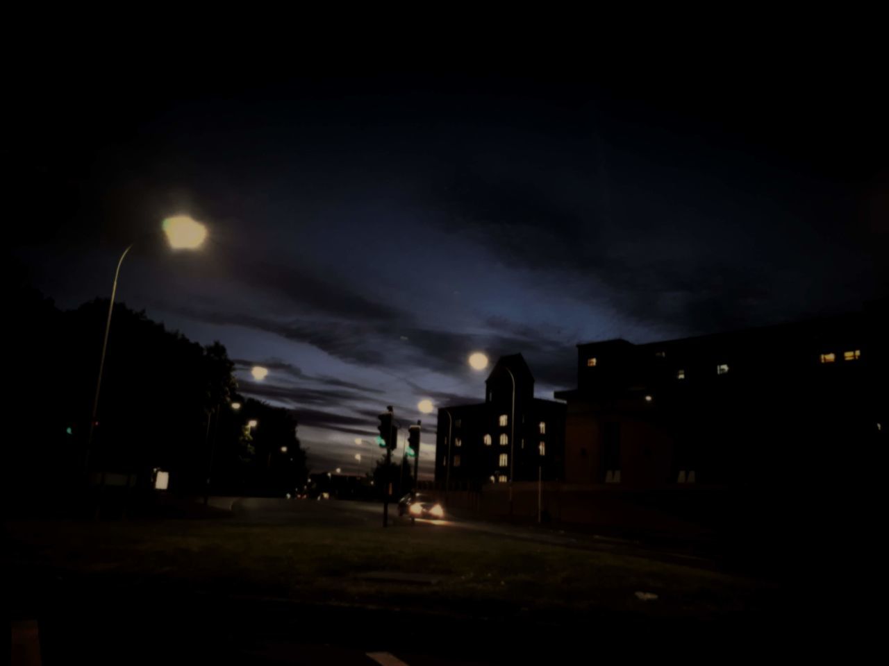 ILLUMINATED STREET AND BUILDINGS AT NIGHT