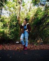 Young woman standing in forest