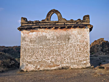 Graffiti done on ancient wall in badami fort , karnataka , india.