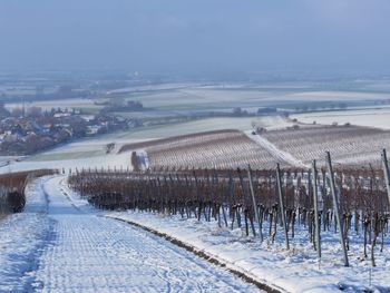 Scenic view of snow covered field against sky