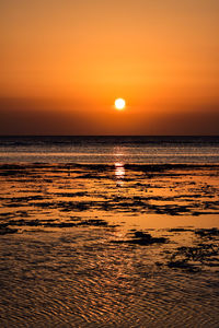 Scenic view of sea against orange sky