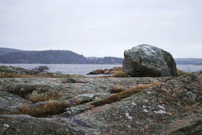 Rocks by sea against sky