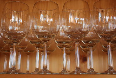 Low angle view of wineglasses on shelf