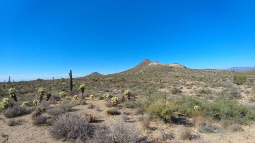 Low angle view of mountain against clear blue sky