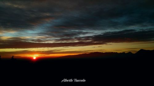 Scenic view of silhouette landscape against dramatic sky