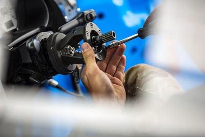 Close-up of man repairing car part