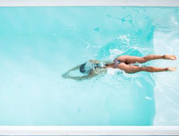 High angle view of woman swimming in pool