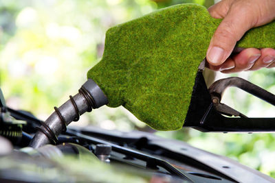 Cropped image of man refueling car