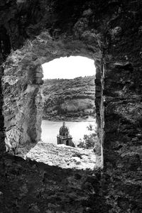 Old ruin seen through arch window