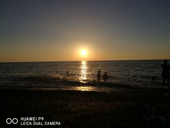 Scenic view of sea against clear sky during sunset