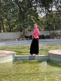 Portrait of woman standing in swimming pool