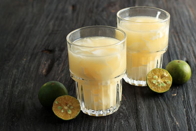 Es kelapa muda jeruk or fresh coconut orange, indonesian typical drink made from oranges squeezed 