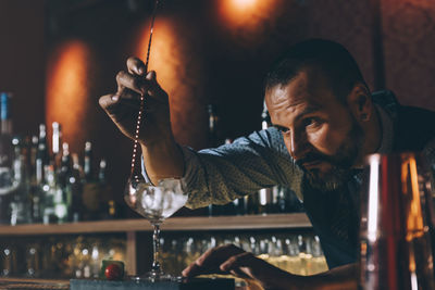 Bartender preparing cocktail in bar