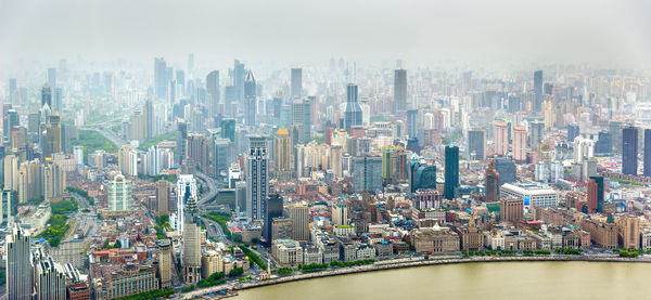 Aerial view of modern buildings in city against sky