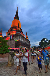 Group of people outside temple against building
