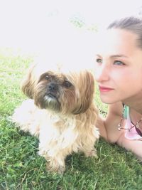 Portrait of woman with dog on grass