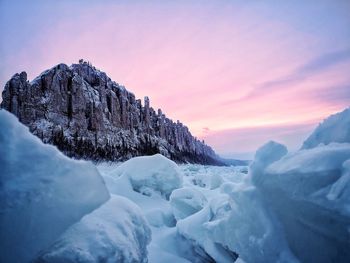 Scenic view of snowcapped mountains against sky during sunset