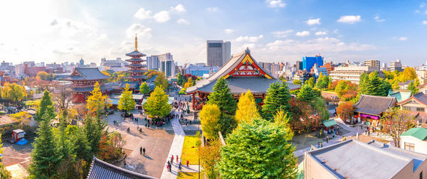 High angle view of trees and buildings against sky