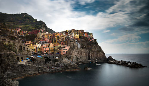 Panoramic view of sea and buildings against sky