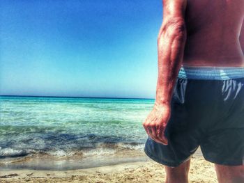High angle view of people standing on beach