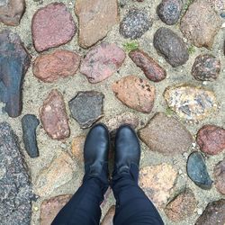 Low section of woman standing on tiled floor