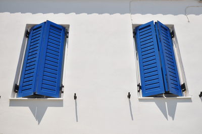 Low angle view of blue windows on wall
