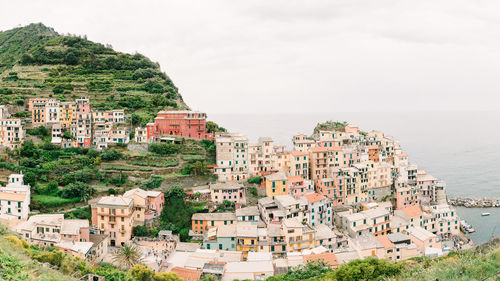 High angle view of townscape by sea against sky