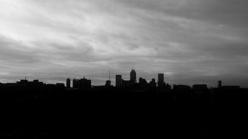 View of cityscape against cloudy sky