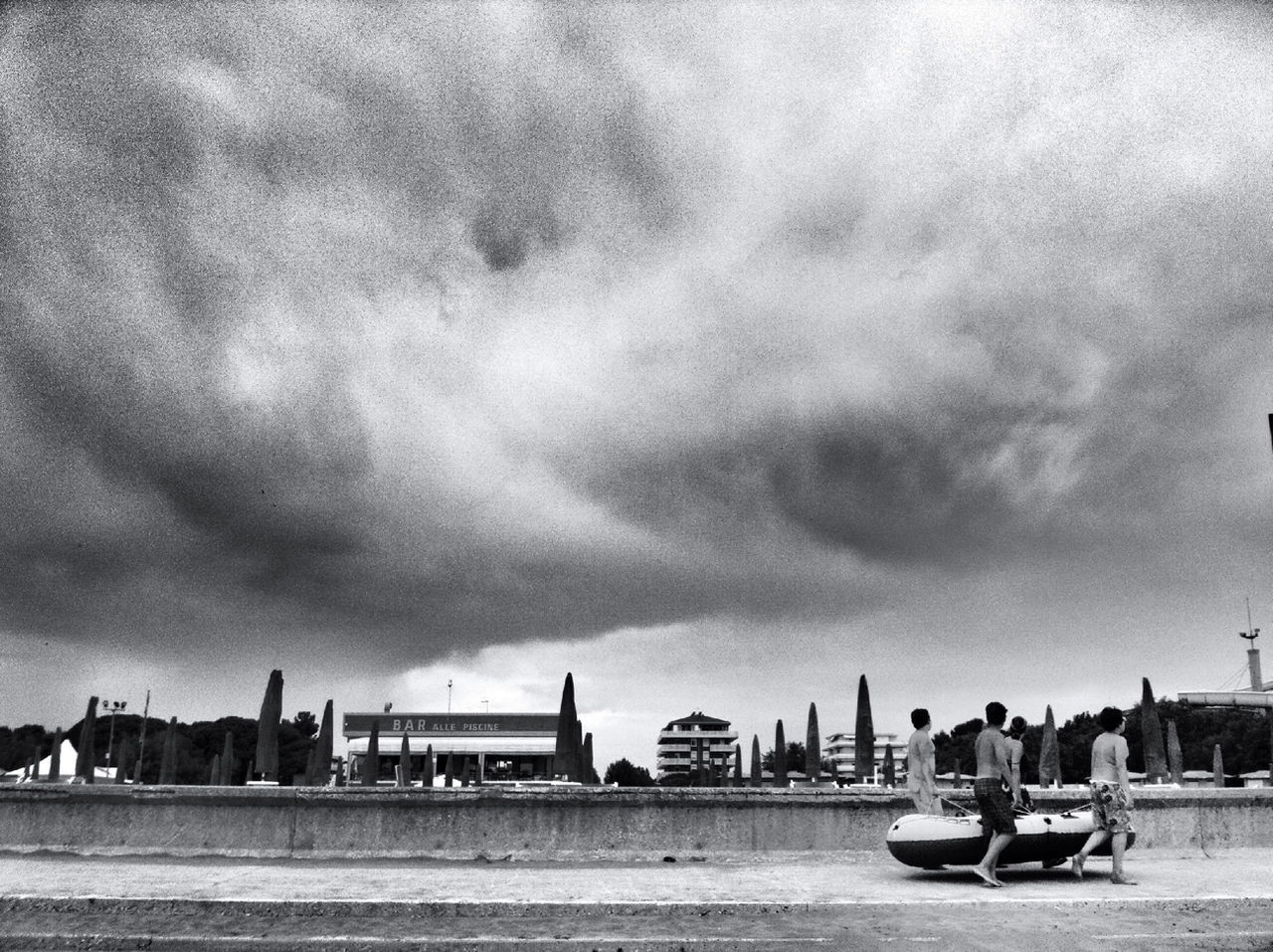 sky, building exterior, architecture, cloud - sky, built structure, cloudy, transportation, mode of transport, overcast, city, weather, nautical vessel, cloud, land vehicle, car, water, storm cloud, outdoors, incidental people, street