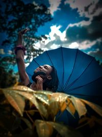 Low angle view of woman looking at sky
