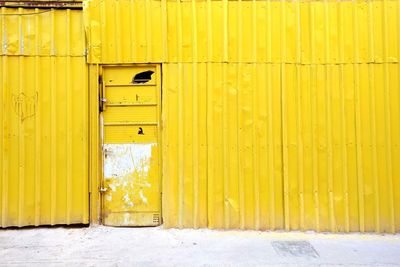 Closed door of yellow building