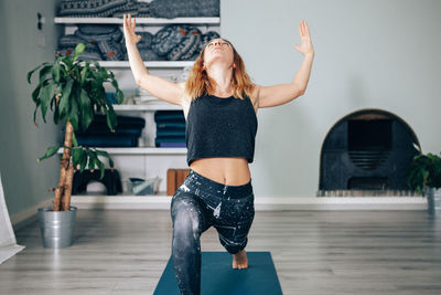 Yogic woman practicing in yoga studio