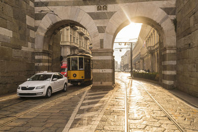 Tram and cars at archi di porta nuova