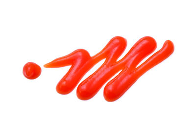 Close-up of red chili peppers against white background