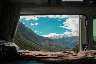 Scenic view of mountains seen through window