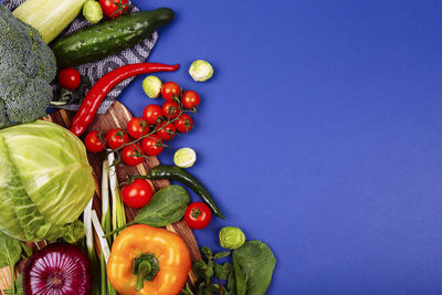High angle view of fruits and vegetables on blue table