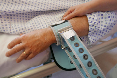 Cropped person lying in hospital bed