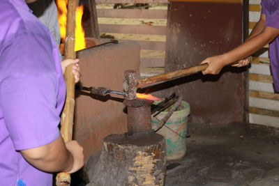 Close-up of manual workers working in metal industry