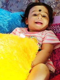 Portrait of cute baby girl sitting outdoors