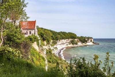 Scenic view of sea and buildings against sky