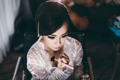 Bride wearing make-up in salon