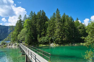 Scenic view of swimming pool by lake against sky