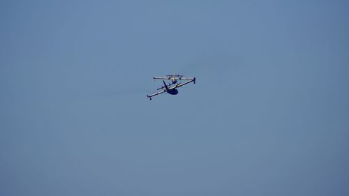 Low angle view of airplane against clear sky