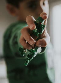 Close-up of boy hand holding toy at home