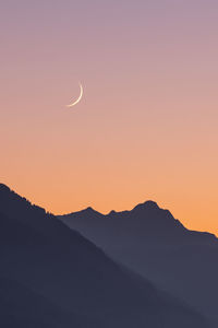 Scenic view of silhouette mountains against sky during sunset