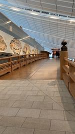 Rear view of people walking on tiled floor