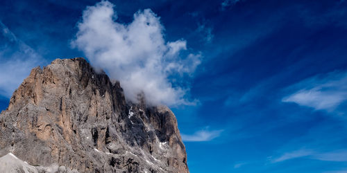 Low angle view of rock formation against sky