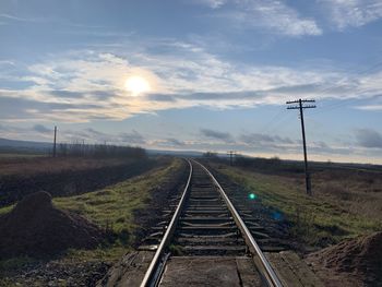 Railroad tracks on land against sky
